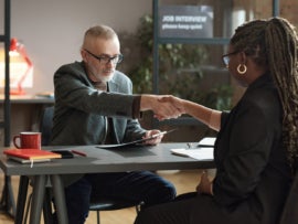 Manager greeting candidate at job interview