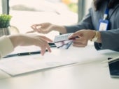 Asian business customer service representatives work serve sell credit card to customers.