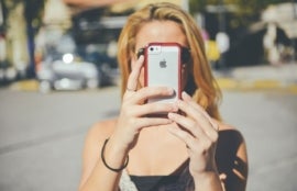 Girl with iPhone taking free photo.