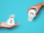 Hands with dollar sign bag and light bulb over blue background.