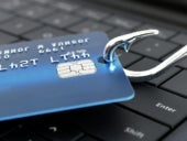 Beware of Phishing Scam Emails - Concept credit card on a fishing hook on computer keyboard