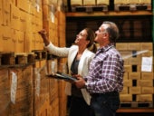 Business owners checking the inventory of their warehouse.