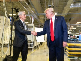 President Trump shakes Tim Cook's hand as he tours the Apple Manufacturing Plant.