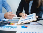 Two business partners analyzing financial reports.