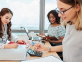 Businesswomen working at big office desk