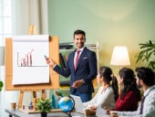 A young man presenting data to a group of people
