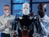 Stock photo of two experts working on a humanoid robot.