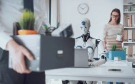 Robot working on laptop in an office