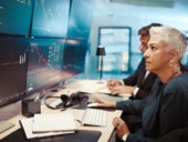 Woman looking at screen for stock trading.