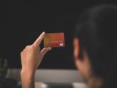 A woman holding her credit card.