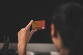 A woman holding her credit card.