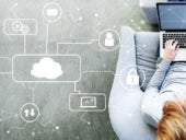 Cloud Computing with man using a laptop in a modern gray chair