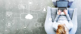 Cloud Computing with man using a laptop in a modern gray chair