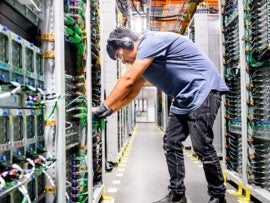 Photo of an employee at an Amazon data center.