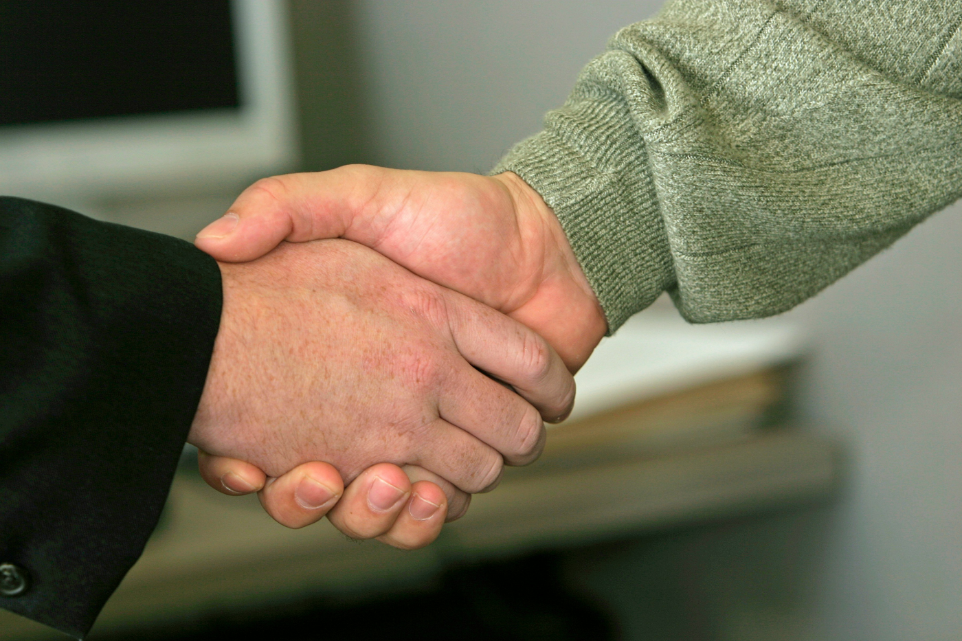 A close up of two people shaking hands