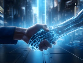 Handshake between a cyber hand a human hand.
