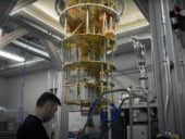 IBM researcher near quantum computer cooling system.