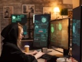 Side view of female hacker writing a dangerous malware.