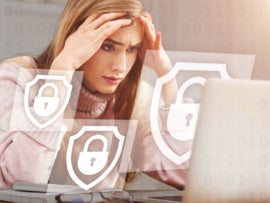 Upset woman holds her head with hands and looks at computer.