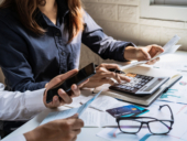 Young couple checking bills, taxes, bank account balance and calculating expenses in the business.