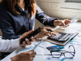 Young couple checking bills, taxes, bank account balance and calculating expenses in the business.