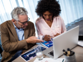 Two businessmen working on a computer