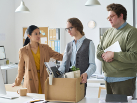 Sad employees being laid off by their boss.