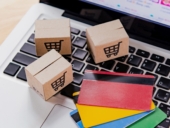 Credit card and cardboard box with a shopping cart.