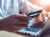 A man checking his credit card online through his laptop.