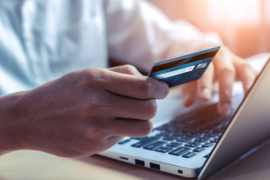 A man checking his credit card online through his laptop.