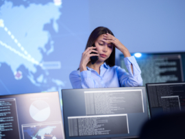 A female cybersecurity officer having an issue with the system and calling someone in the phone.