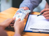business people negotiating contracts with the documents on the table and sign the contract