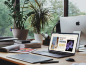 An office desk with computer and tablet.