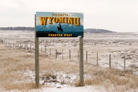 Welcome to Wyoming Forever West State entry sign.