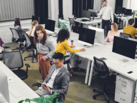 high angle view of young multiethnic businesspeople working with digital devices in open space
