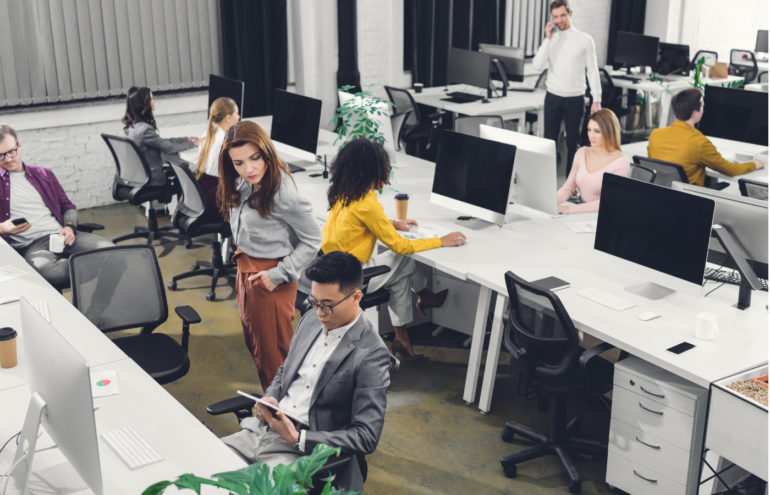 high angle view of young multiethnic businesspeople working with digital devices in open space
