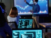 Male business trainer is against projector with data, teaching people