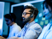 Professional call center agents with headsets providing friendly customer support.