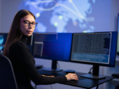 Female IT Consultant in cyber security team working to prevent security threats.