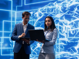 Researchers collaborating on developing AI system in high tech workspace.