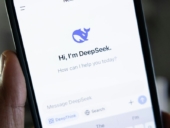 Aperson holding a phone with DeepSeek on the screen