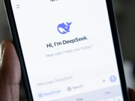 Aperson holding a phone with DeepSeek on the screen