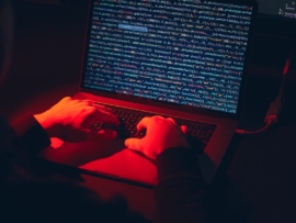 Man using computer and programming to break code.