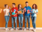 Young students of language school near color wall