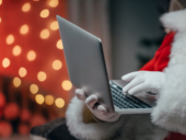cropped view of santa claus using laptop