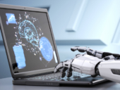 Robot's hands typing on laptop keyboard.