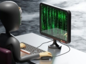 Android robot working on a computer