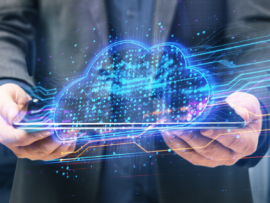 Professional holding tablet with blue glowing cloud computing diagram