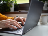 hands working on a laptop