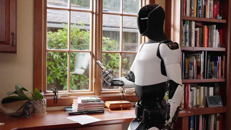 Tesla robor holding a smartphone.